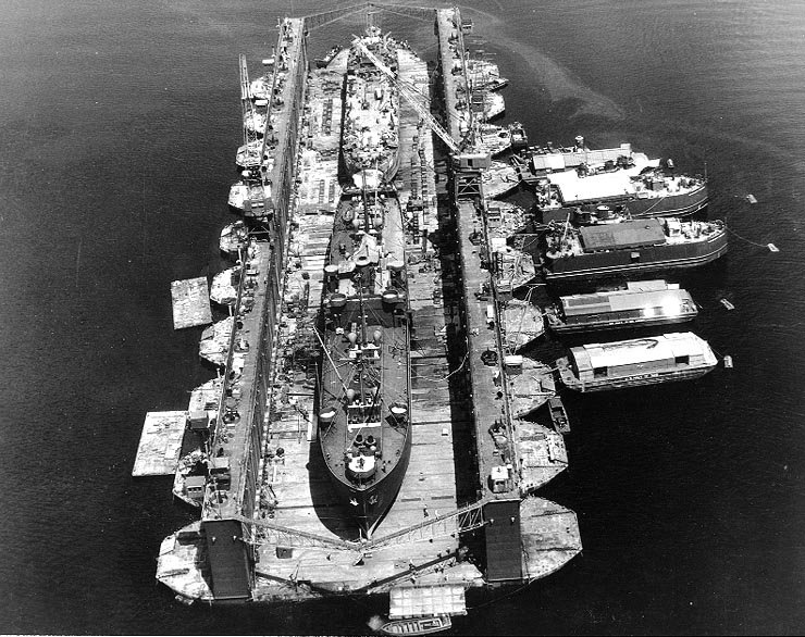 USS Artisan (ABSD-1) with Antelope (IX-109) and LST-120 in the dock at Espiritu Santo, New Hebrides Islands, 8 January 1945..jpg